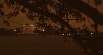 The Lincoln (?) Memorial from the other side of the river, framed by the boughs of a tree