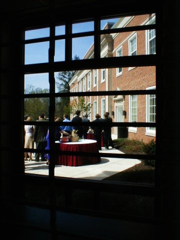 Wedding outside of the Tempest Theatre, Elizabethtown College. Viewed through the Brossman Commons window and the information desk grille